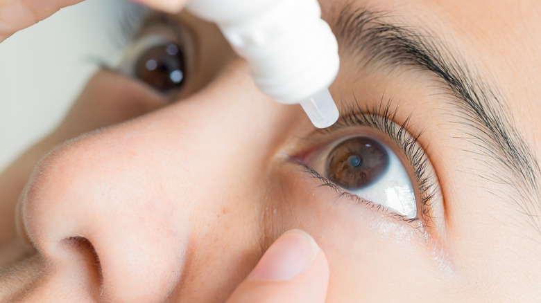 Woman using eye drops