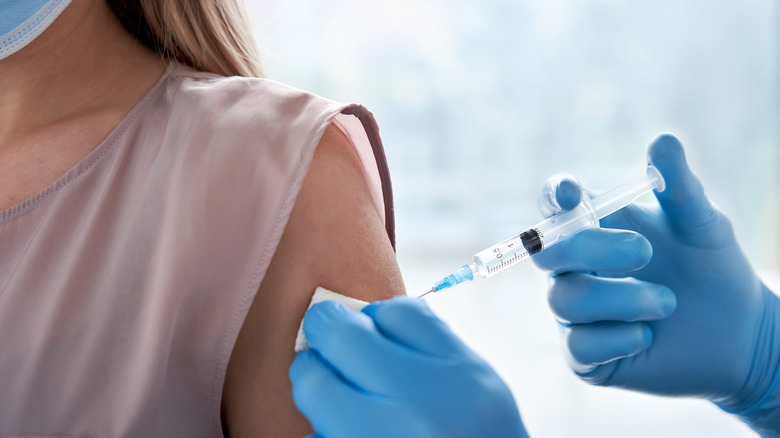 A woman gets the COVID vaccine