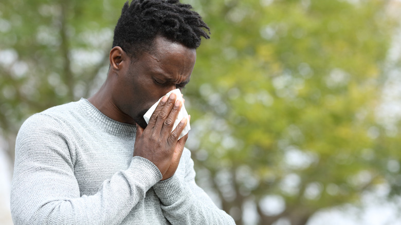 man blowing nose