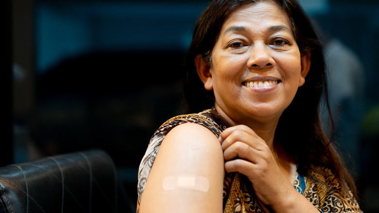 woman showing her vaccination site