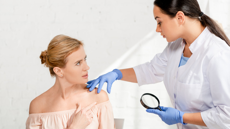 Woman speaking to dermatologist