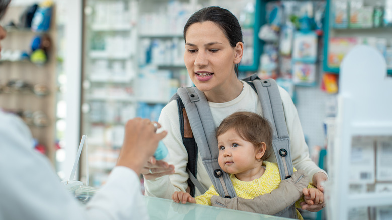 Woman with baby at pharmacy