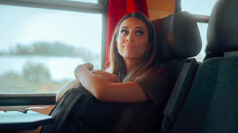 A woman sitting on a train