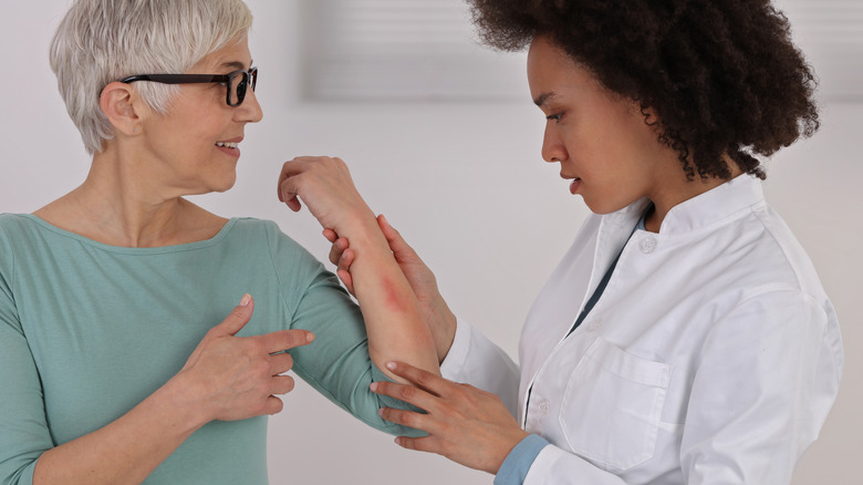 Woman showing irritation to doctor