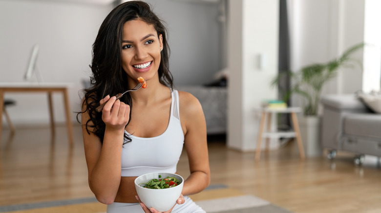 Woman eating salad