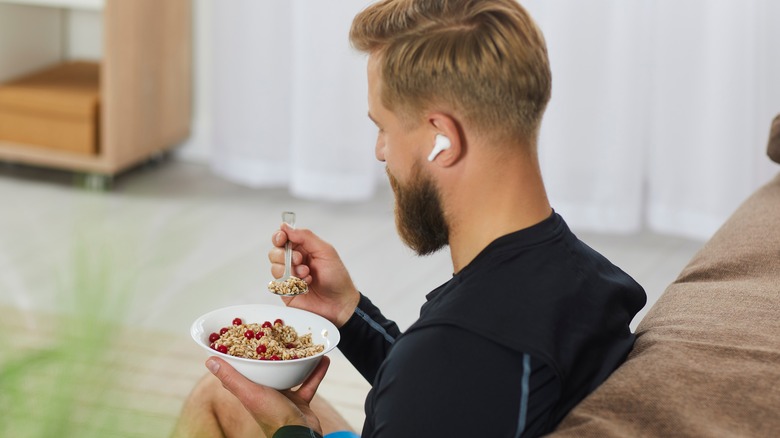 Man eating bowl of oats