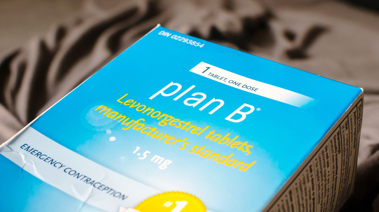 a box of plan b lays on the bed 