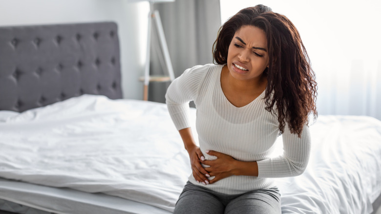 Woman holding side with pain 