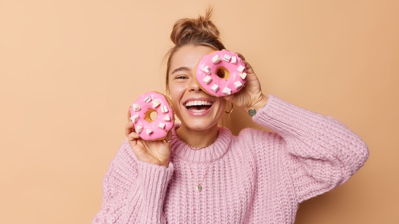 girl holding donuts