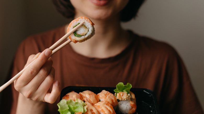 woman eating sushi