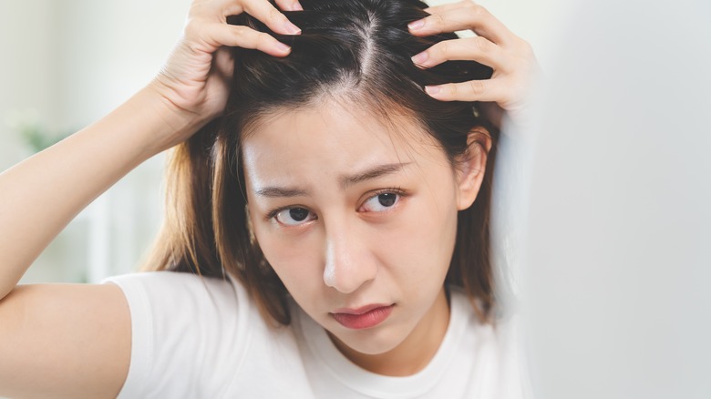 Person looking at thinning hair 