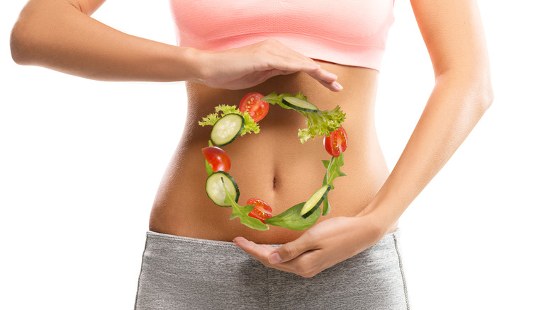 woman holding salad ring over stomach