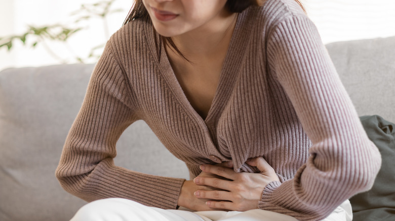 young woman experiencing abdominal cramps