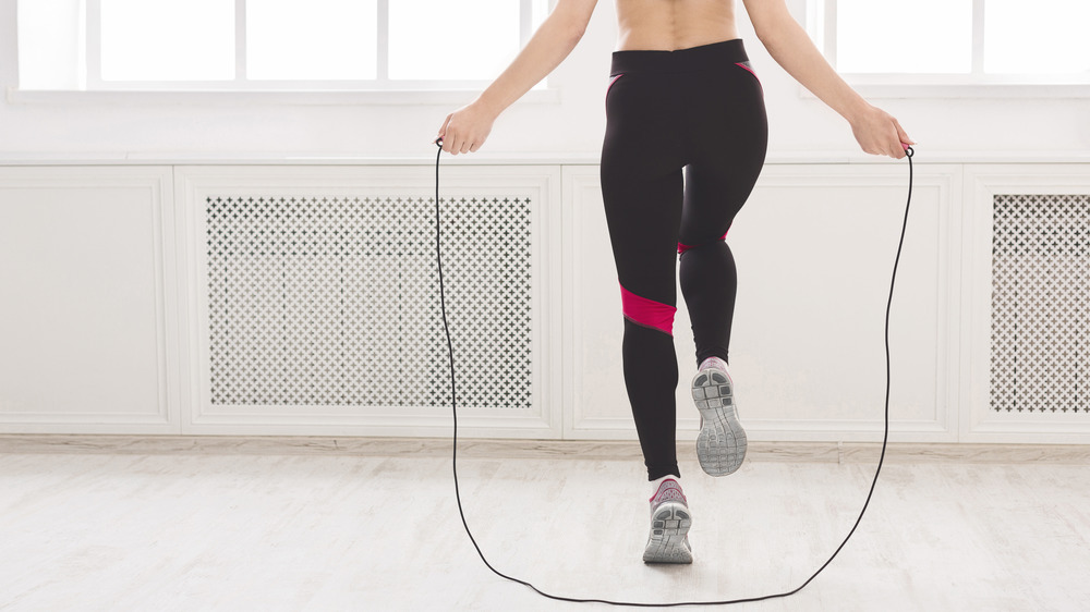 A woman's lower body as she jumps rope