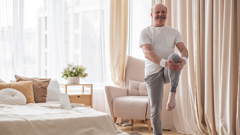 Older man practicing Pilates