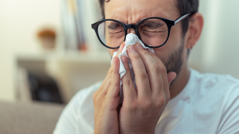 Man blowing his nose