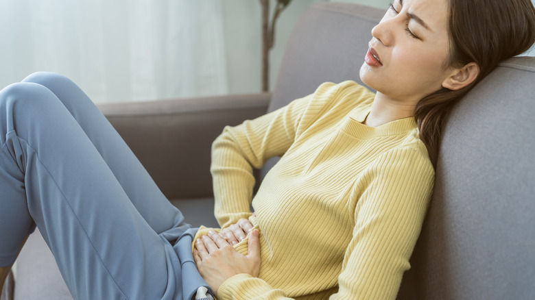 Woman with hand on her stomach