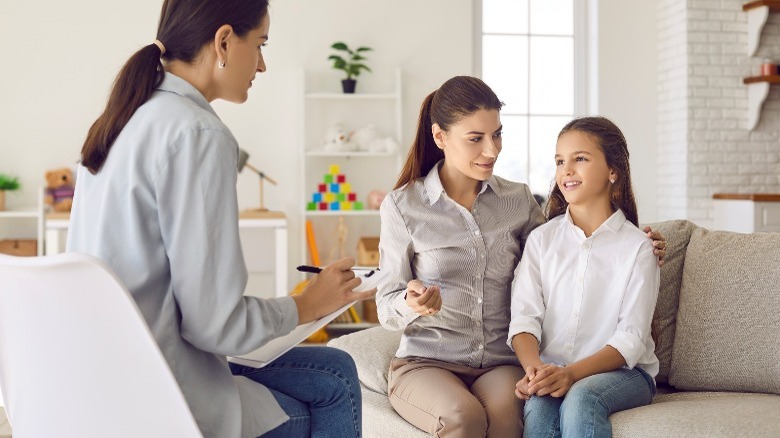 mother and daughter talk to healthcare professional 