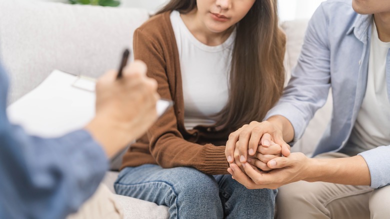 Woman and husband with doctor