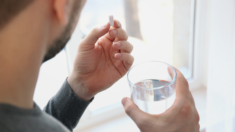 man taking medication