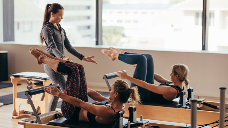 Three woman in a Pilates class