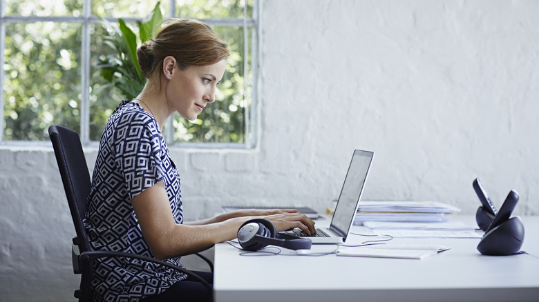 woman working on her laptop at her desk