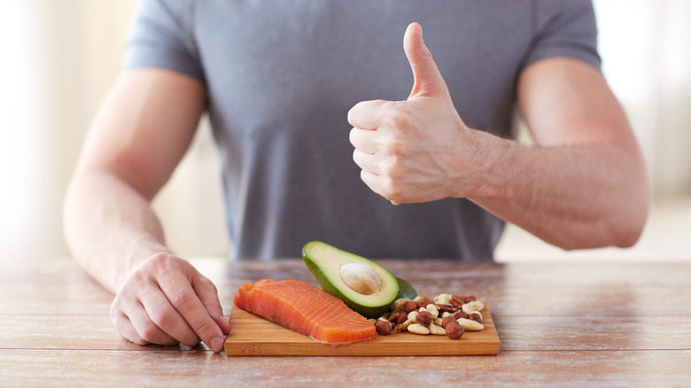 Man giving foods thumbs up