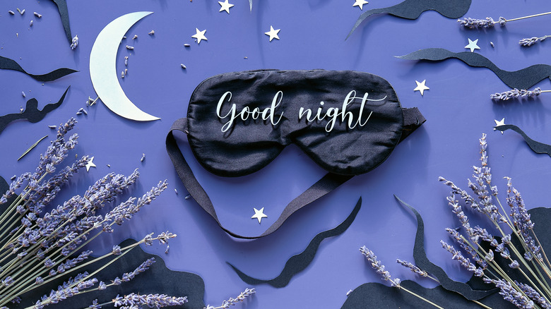 A sleep mask surrounded by stars and lavender 