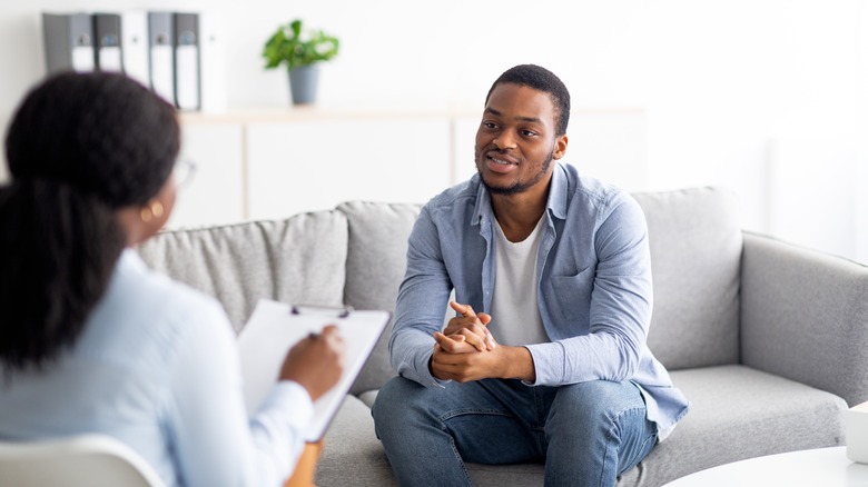 Young man talking to doctor