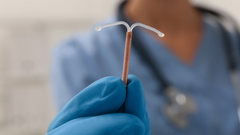 doctor holding IUD