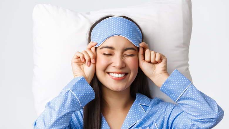 woman in bed wearing a sleep mask