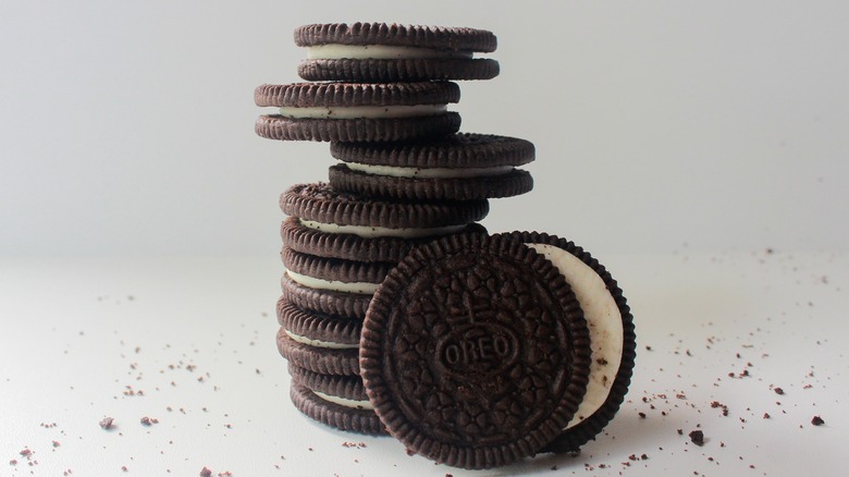 Oreo cookies stacked on white surface