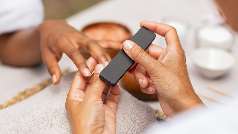 Close up of woman's hands getting a manicure