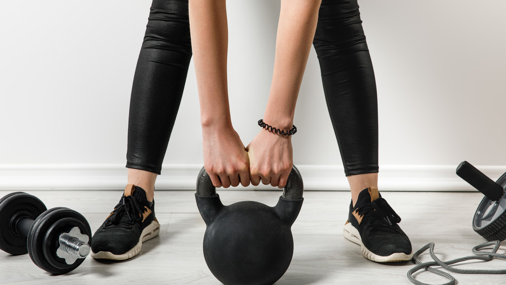 person holding kettlebell