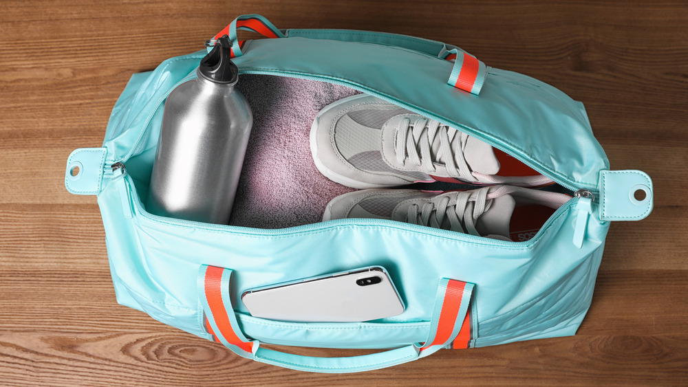 packed gym bag with shower shoes