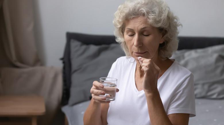 Individual taking medication at night