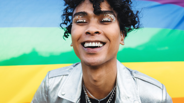 Smiling person wearing glittery eye makeup 