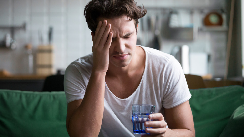 hungover man drinking water