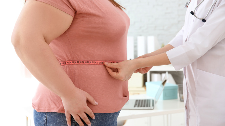 Woman being measured at doctor's office