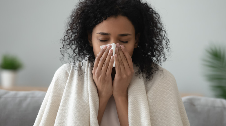 Woman blowing nose