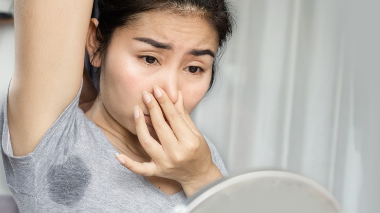 woman holding her nose at smell