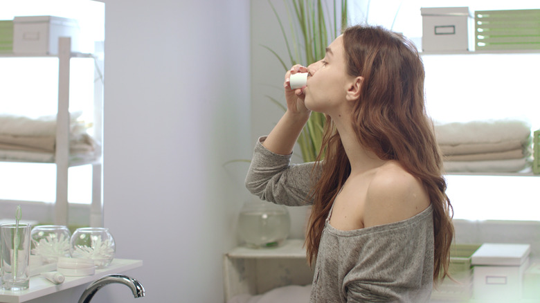 Woman rinsing mouth