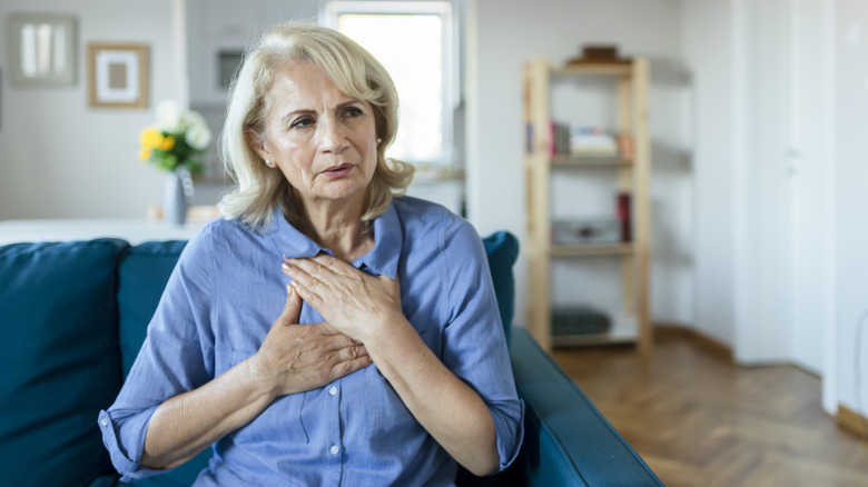 Woman clutching chest