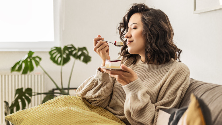 Person hunched over eating