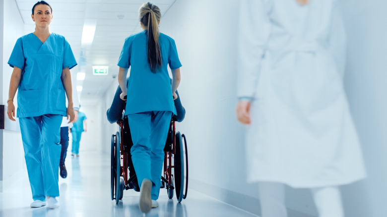 nurse pushing wheelchair