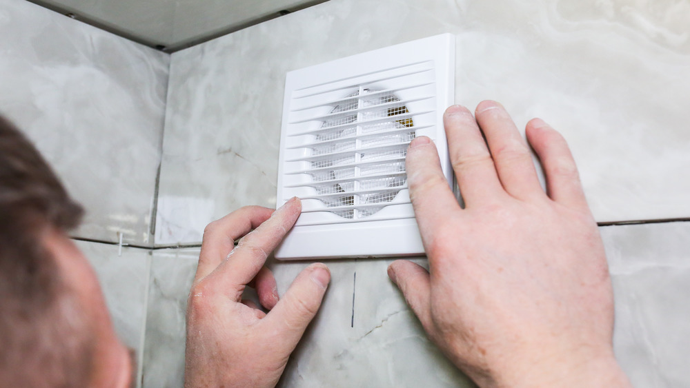 person checks bathroom fan