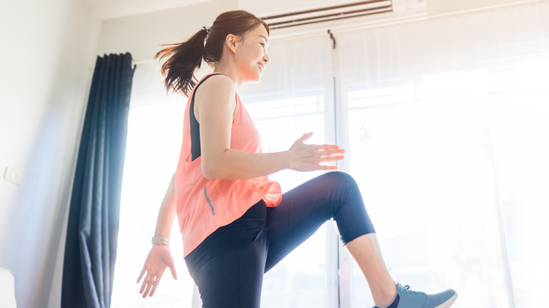 Woman doing aerobics at home