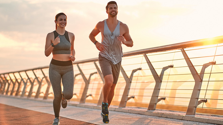 Couple running together outside