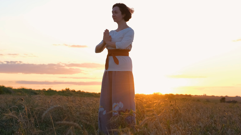 Woman practicing qigong outside 