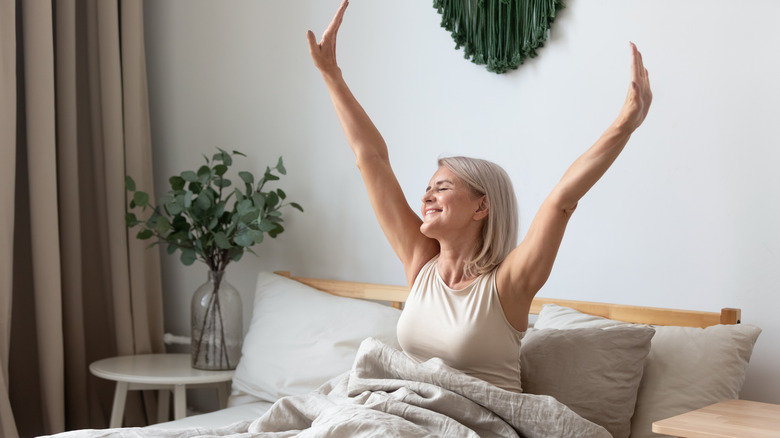 Woman stretching in bed